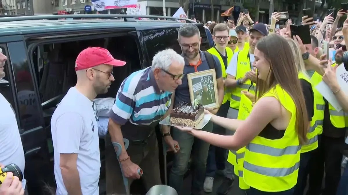 Belgrade students surprise injured 90-year-old protest supporter with birthday celebration